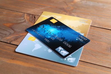 Photo of Many credit cards on wooden table, closeup