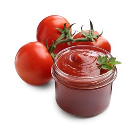 Photo of Tasty ketchup in glass jar and fresh tomatoes isolated on white