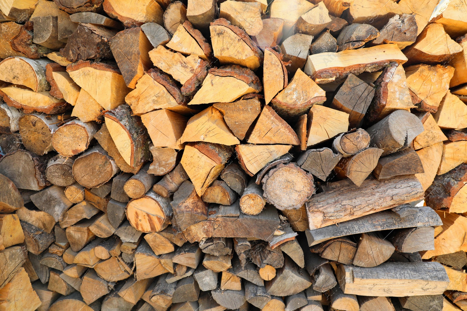 Photo of Stacked firewood as background. Heating in winter