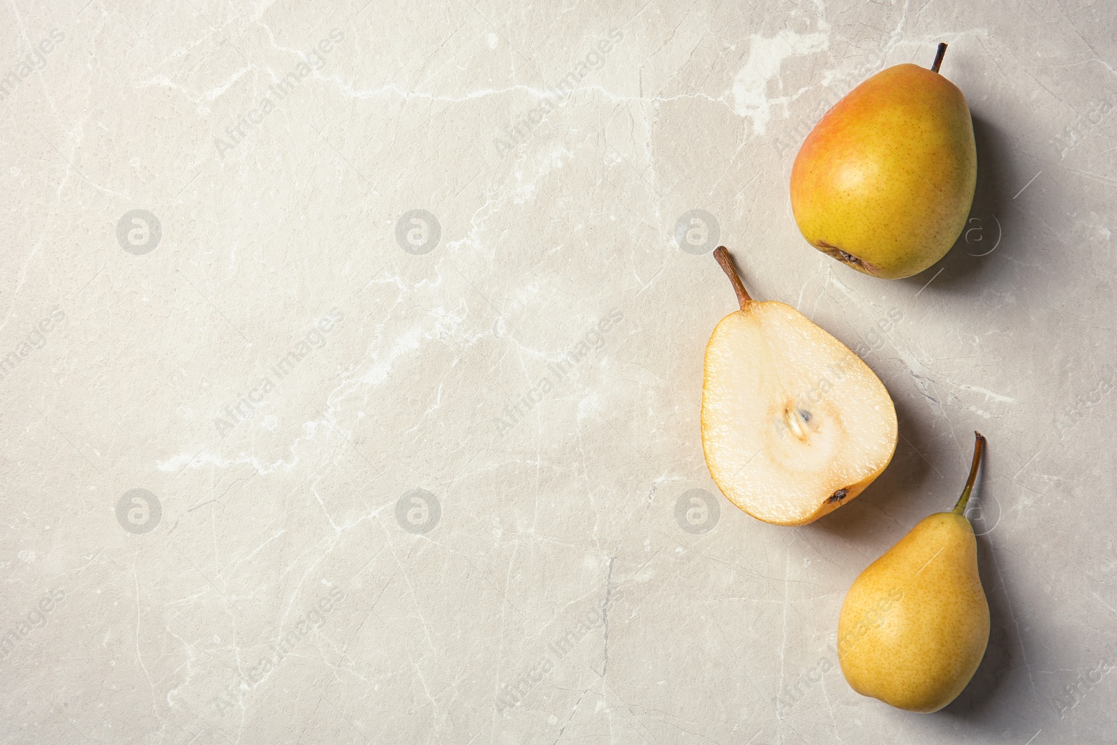 Photo of Ripe pears on grey background, top view. Space for text