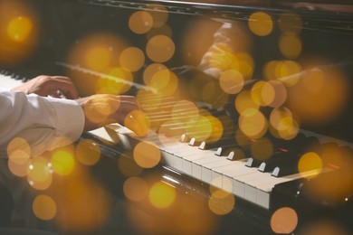 Christmas and New Year music. Man playing piano, closeup. Bokeh effect