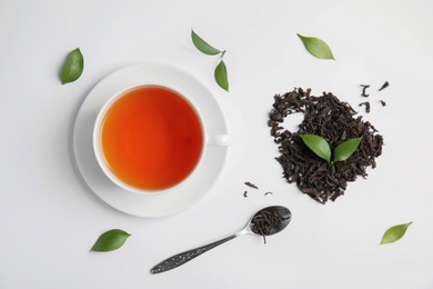 Flat lay composition with delicious tea on light background