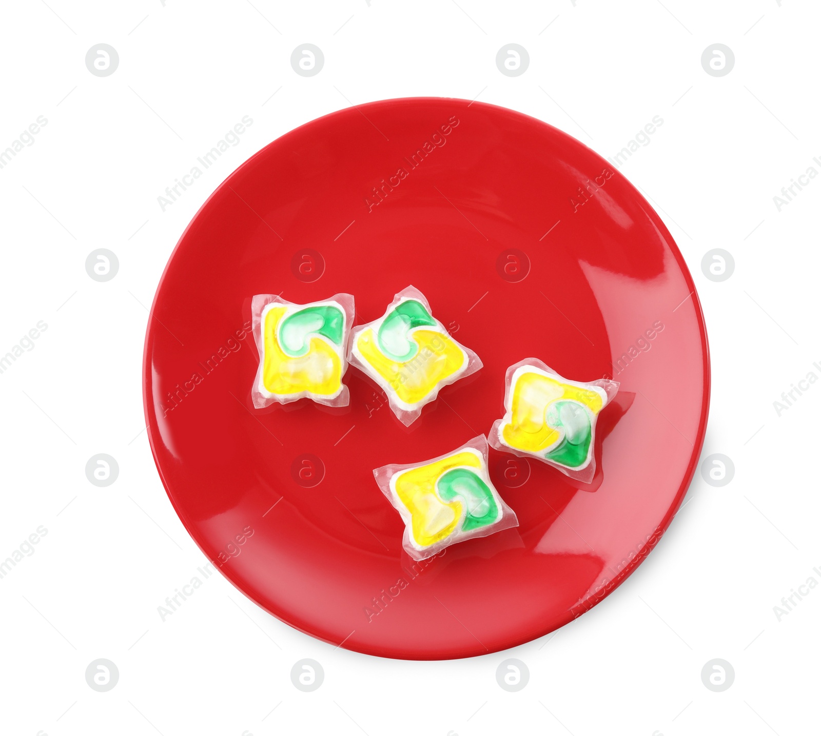 Photo of Red plate with many dishwasher detergent pods on white background, top view