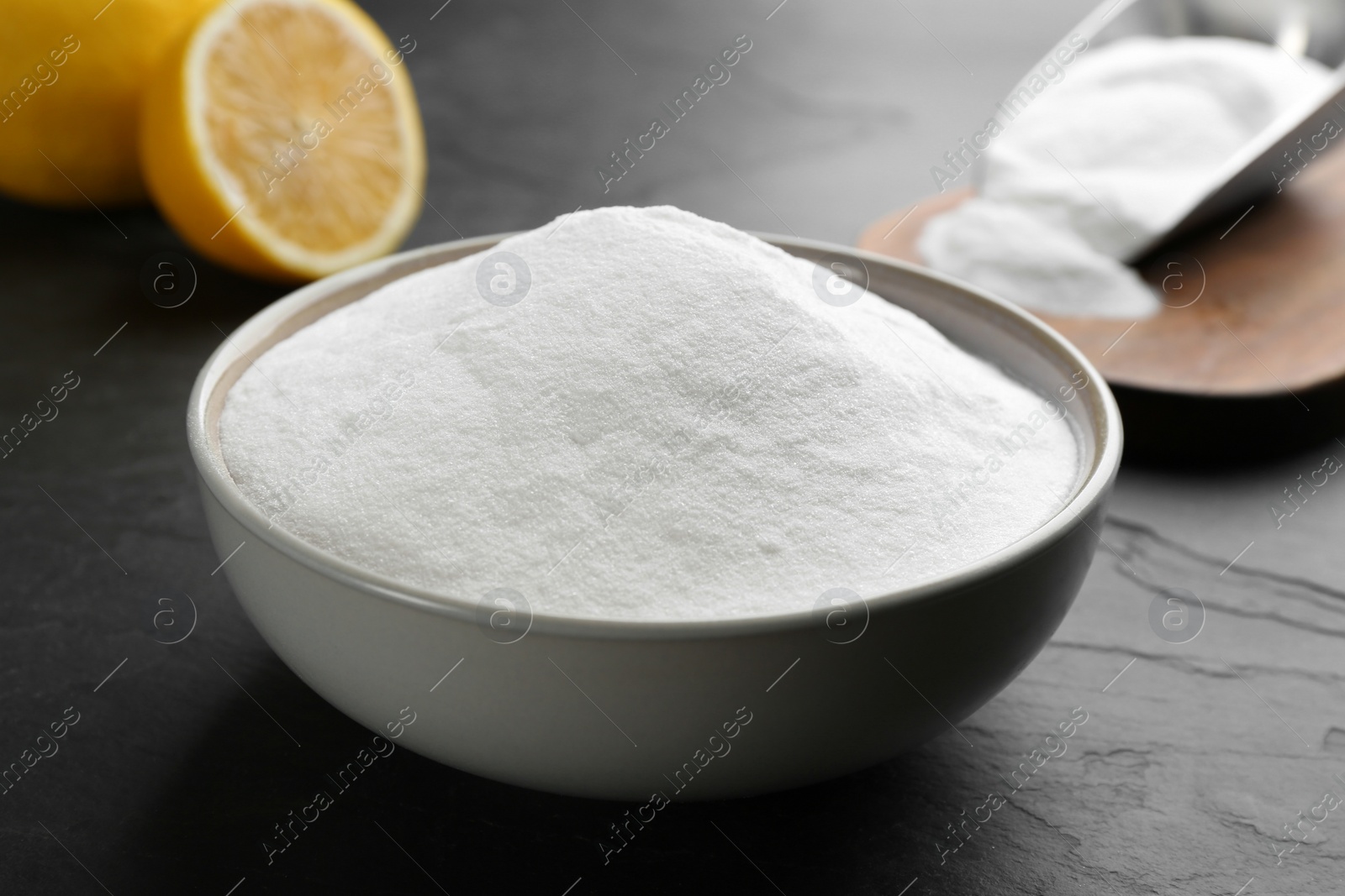 Photo of Baking soda in bowl on black table