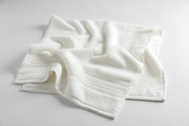 Photo of Clean soft terry towel on light background