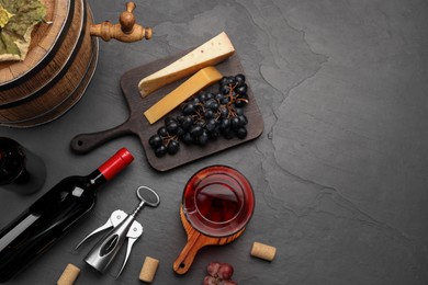 Photo of Winemaking. Flat lay composition with tasty wine and wooden barrel on gray table, space for text