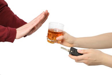Photo of Man refusing alcoholic drink while woman suggesting him car keys and glass of whiskey on white background, closeup. Don't drink and drive concept