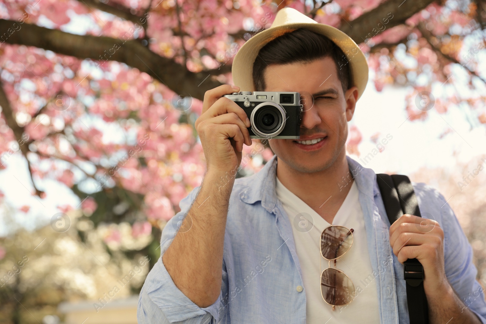 Photo of Tourist taking picture on beautiful city street