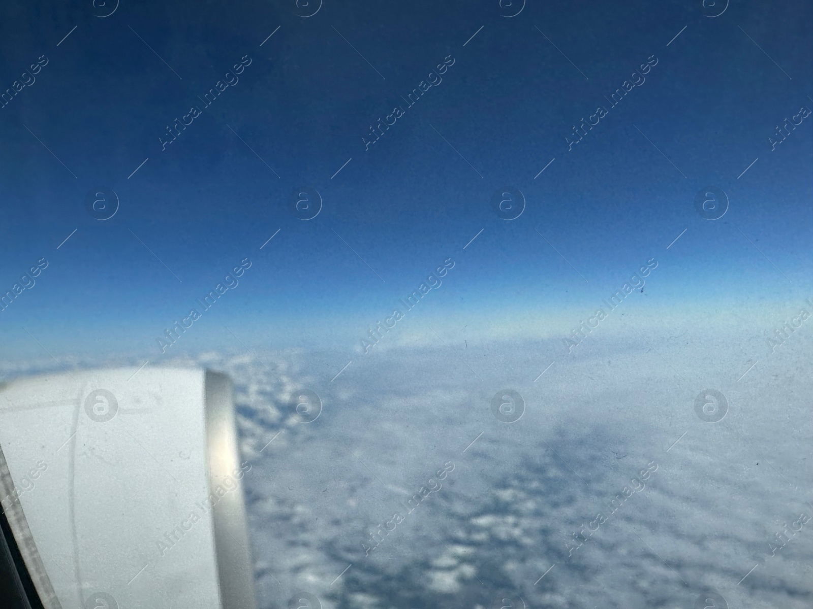 Photo of Beautiful blue sky with fluffy clouds, view from plane window