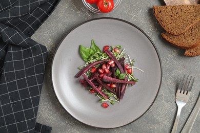 Photo of Delicious fresh carrot salad served on grey table, flat lay