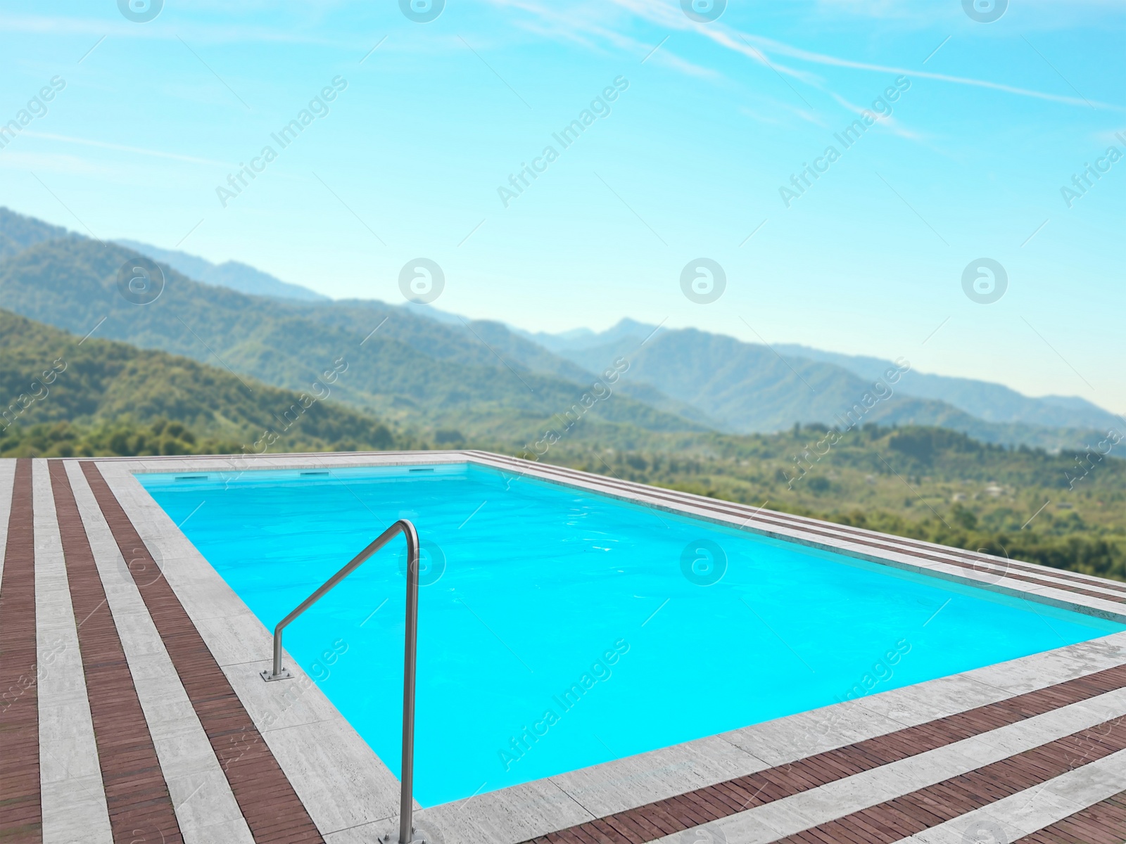 Image of Outdoor swimming pool at luxury resort with beautiful view of mountains on sunny day