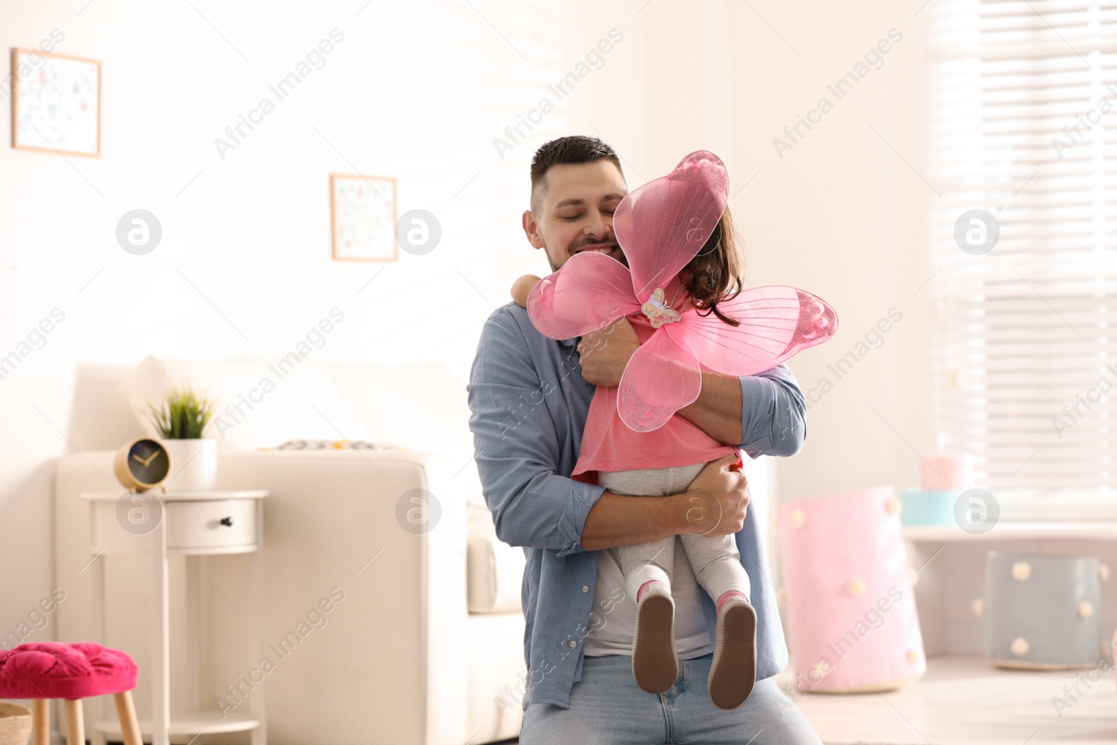 Photo of Father playing with his child at home