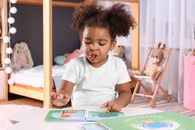 African American girl reading book at home