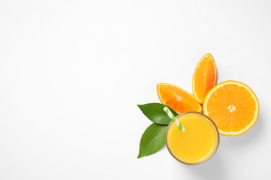 Photo of Glass of orange juice and fresh fruits on white background, top view