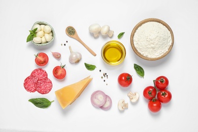 Flat lay composition with fresh ingredients for pizza on white background