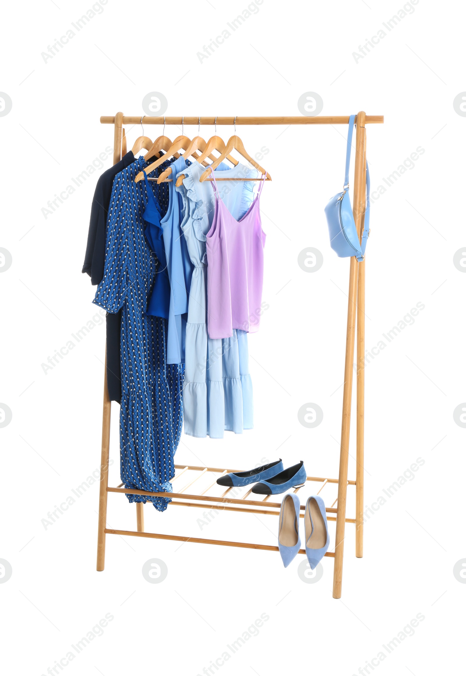 Photo of New wardrobe rack with stylish lady's clothes and shoes on white background