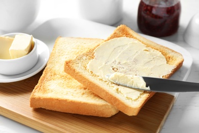 Tasty breakfast with toasts on white table