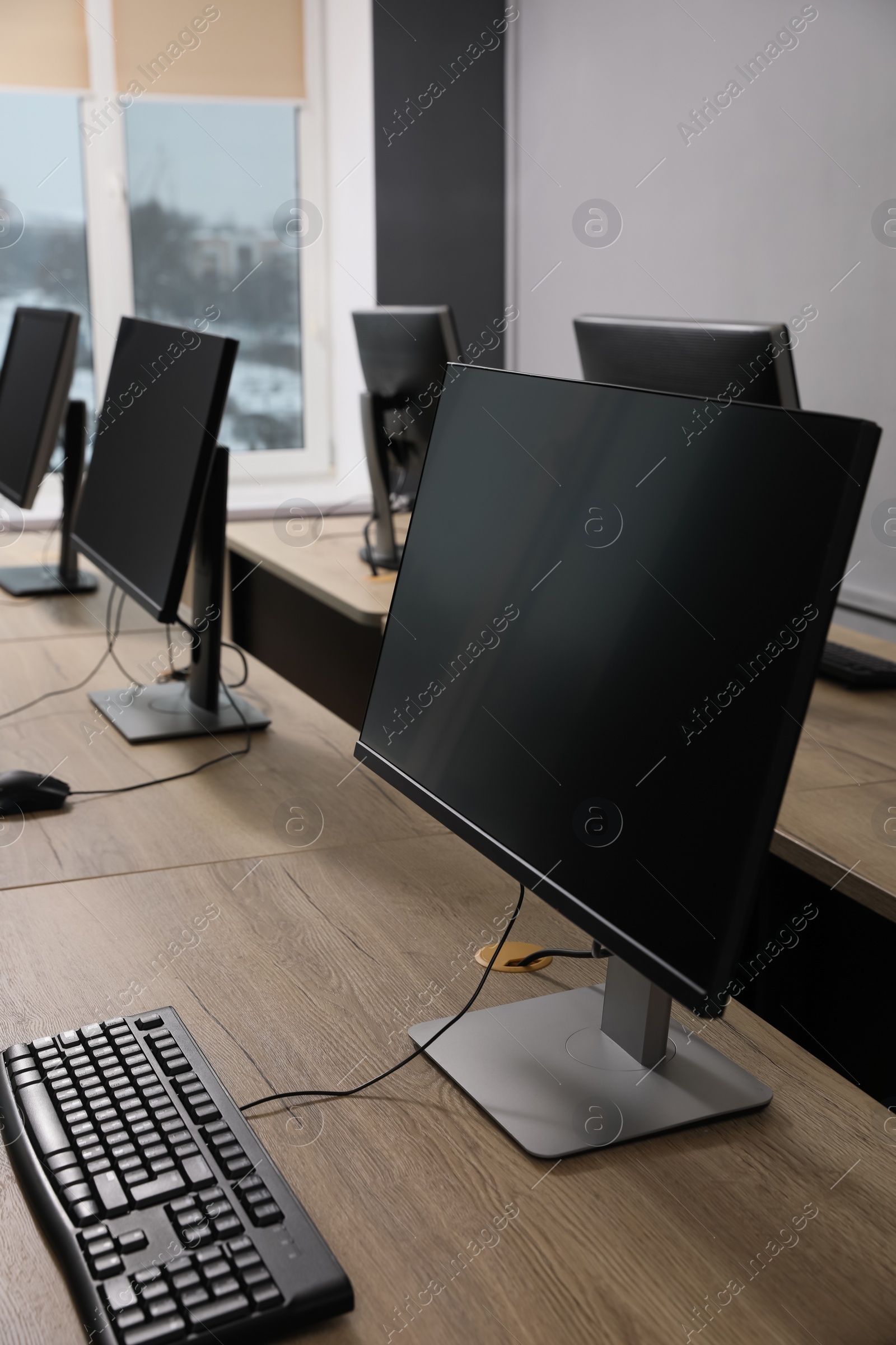 Photo of Many modern computers in open space office