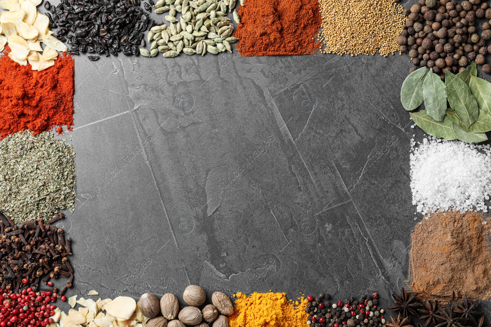 Photo of Frame made with different spices on grey background, flat lay. Space for text