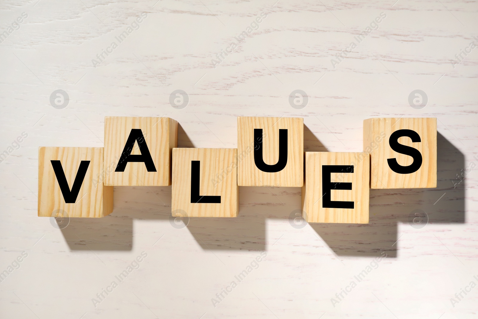 Photo of Cubes with word VALUES on white wooden background, flat lay