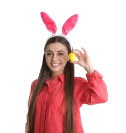 Photo of Beautiful woman in bunny ears headband holding Easter egg on white background