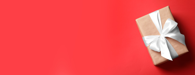 Image of Beautiful gift box and space for text on red background, top view. Banner design