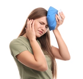 Unhappy woman using cold pack to cure headache on white background