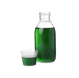 Photo of Bottle with measuring cup of syrup on white background. Cough and cold medicine