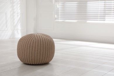 Stylish beige pouf in room, space for text