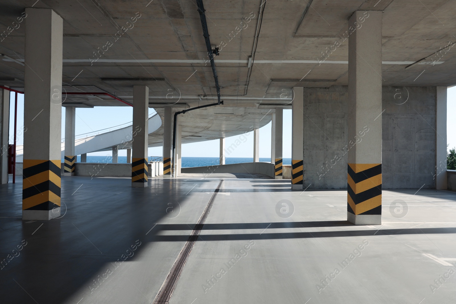 Photo of Empty open car parking near sea on sunny day