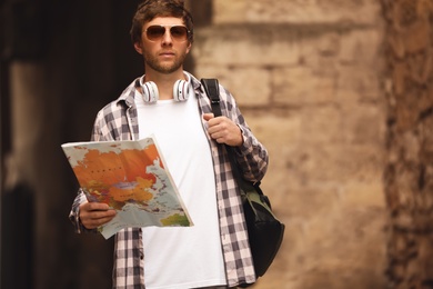 Photo of Traveler with world map on city street