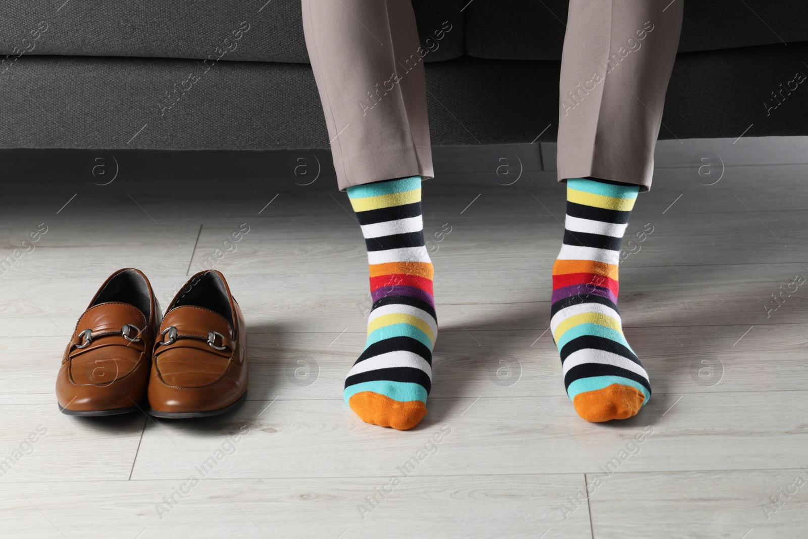 Photo of Man wearing colorful socks indoors, closeup view