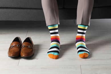 Man wearing colorful socks indoors, closeup view