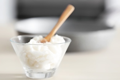 Photo of Bowl with coconut oil on kitchen table