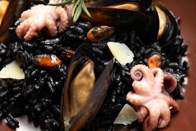 Photo of Delicious black risotto with seafood, closeup view