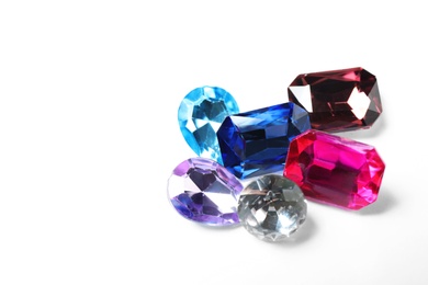 Photo of Different beautiful bright gemstones on white background