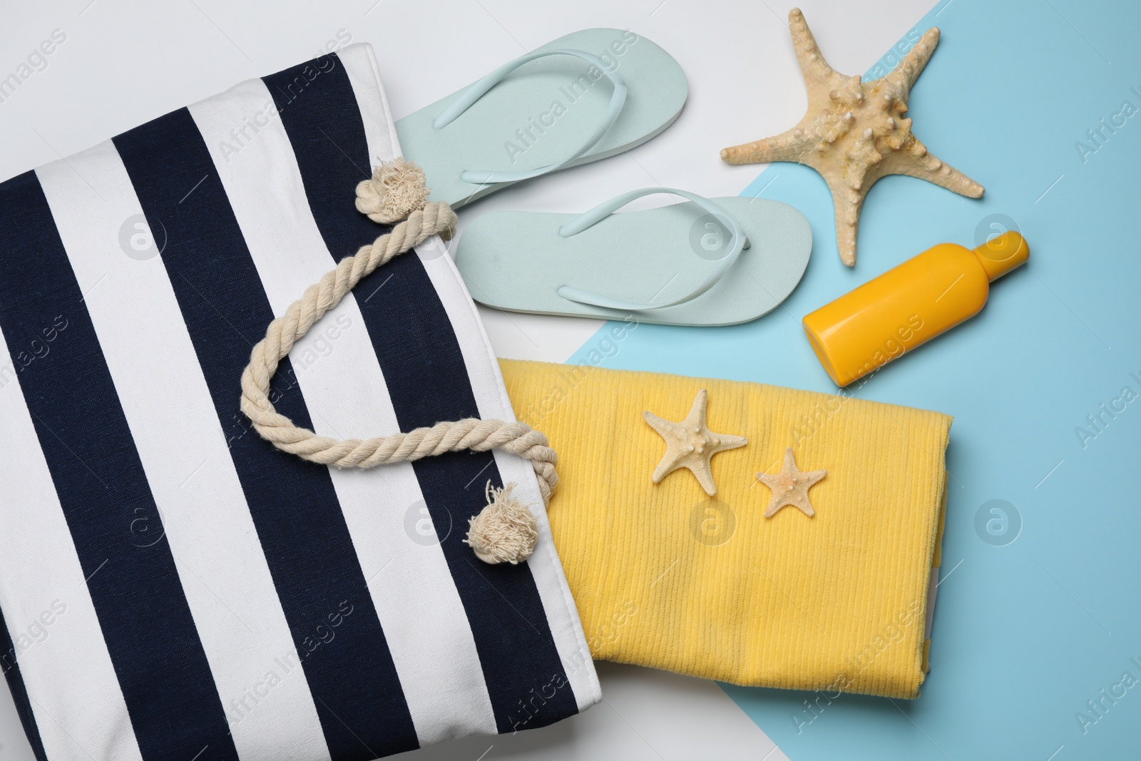 Photo of Stylish bag and beach accessories on color background, flat lay