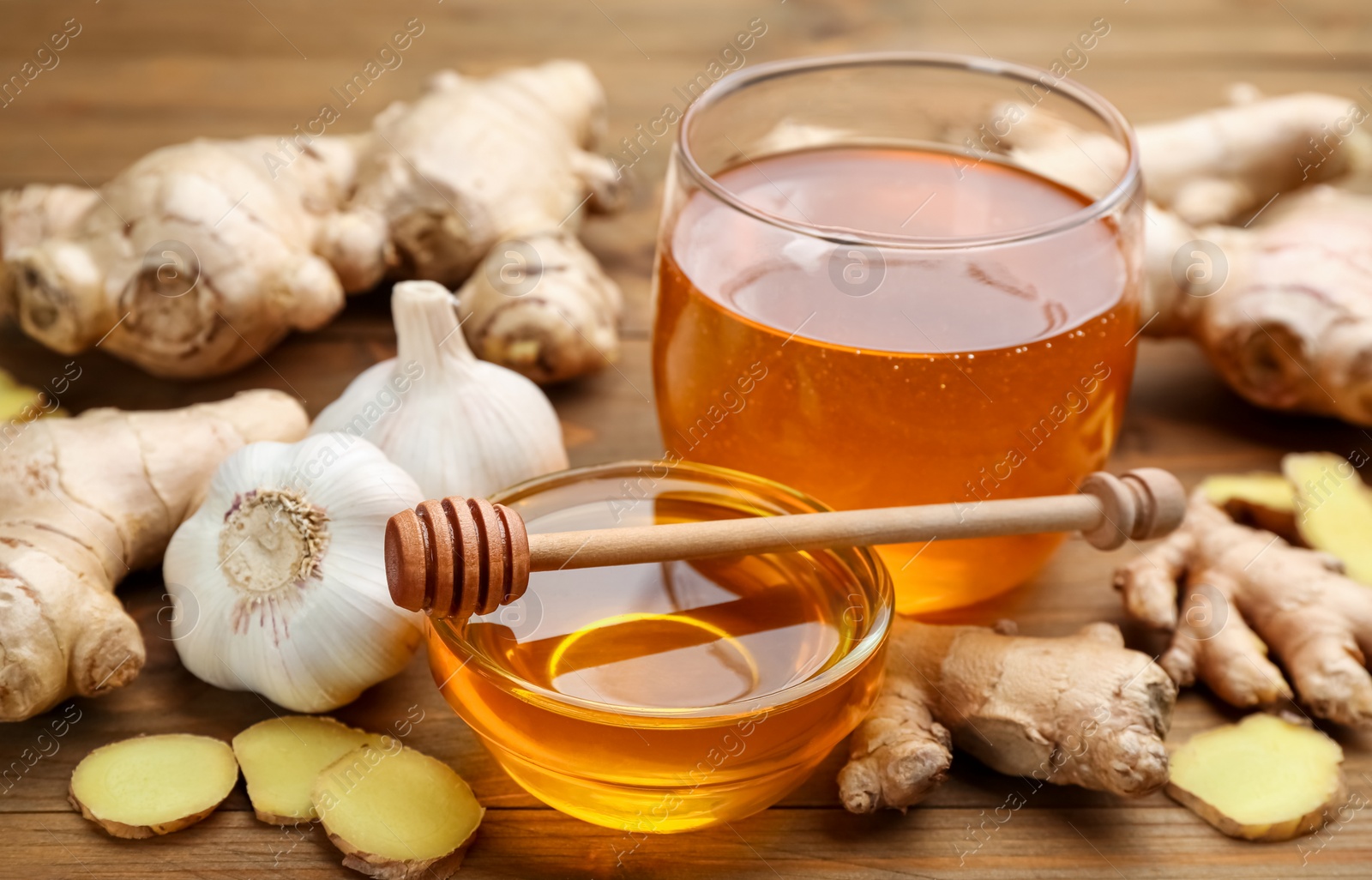 Photo of Ginger, garlic and honey on wooden table. Natural cold remedies