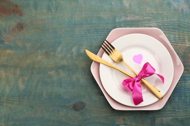 Photo of Beautiful table setting on wooden background, top view with space for text. Valentine's Day dinner