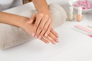 Photo of Woman showing neat manicure at table, closeup with space for text. Spa treatment