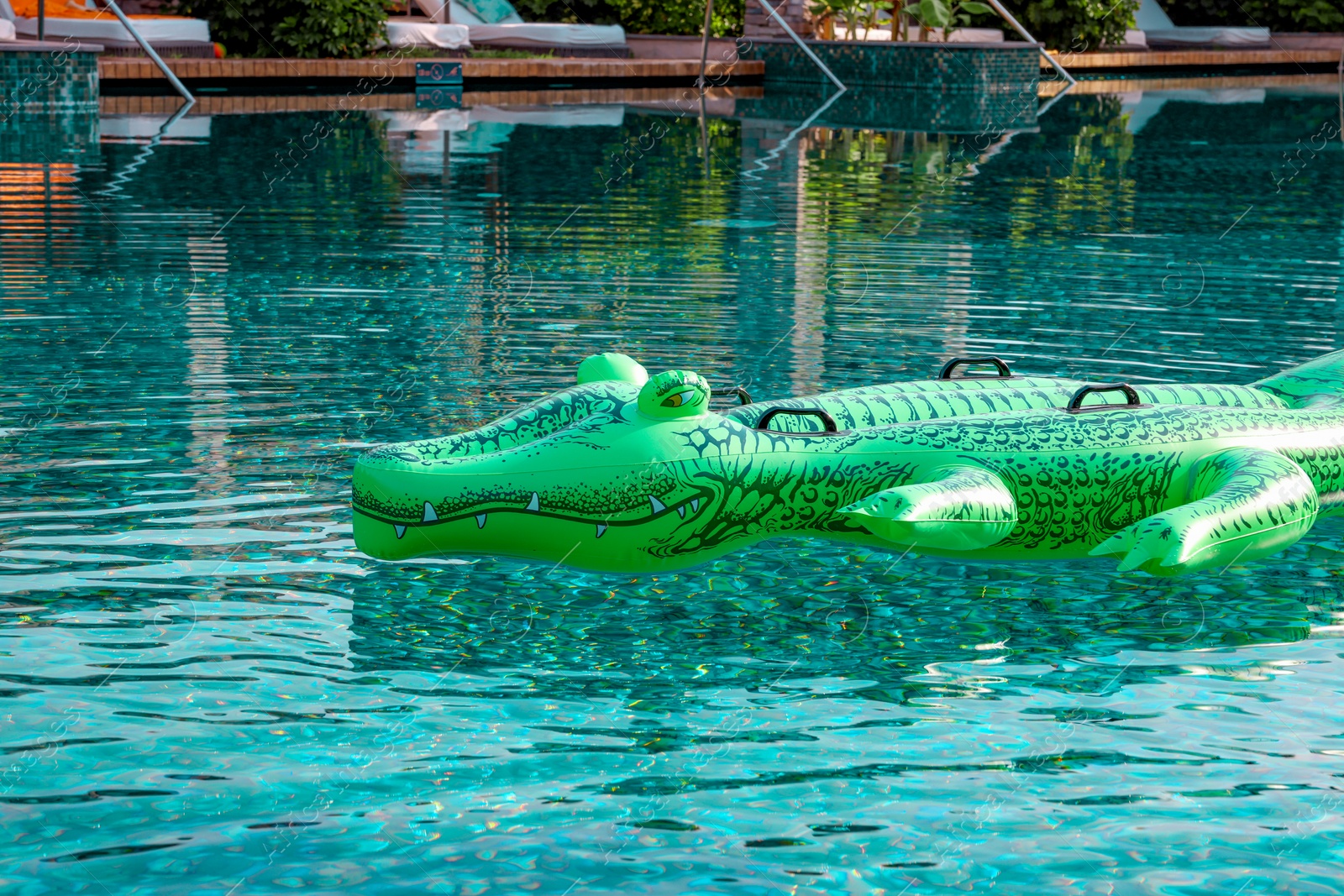 Photo of Float in shape of crocodile in swimming pool at luxury resort