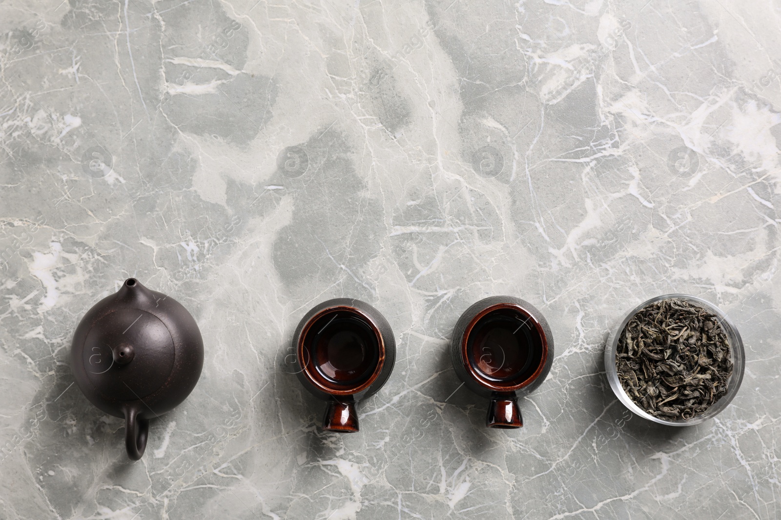 Photo of Beautiful traditional tea ceremony set on light grey marble table, flat lay. Space for text