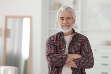 Photo of Portrait of happy grandpa with grey hair indoors