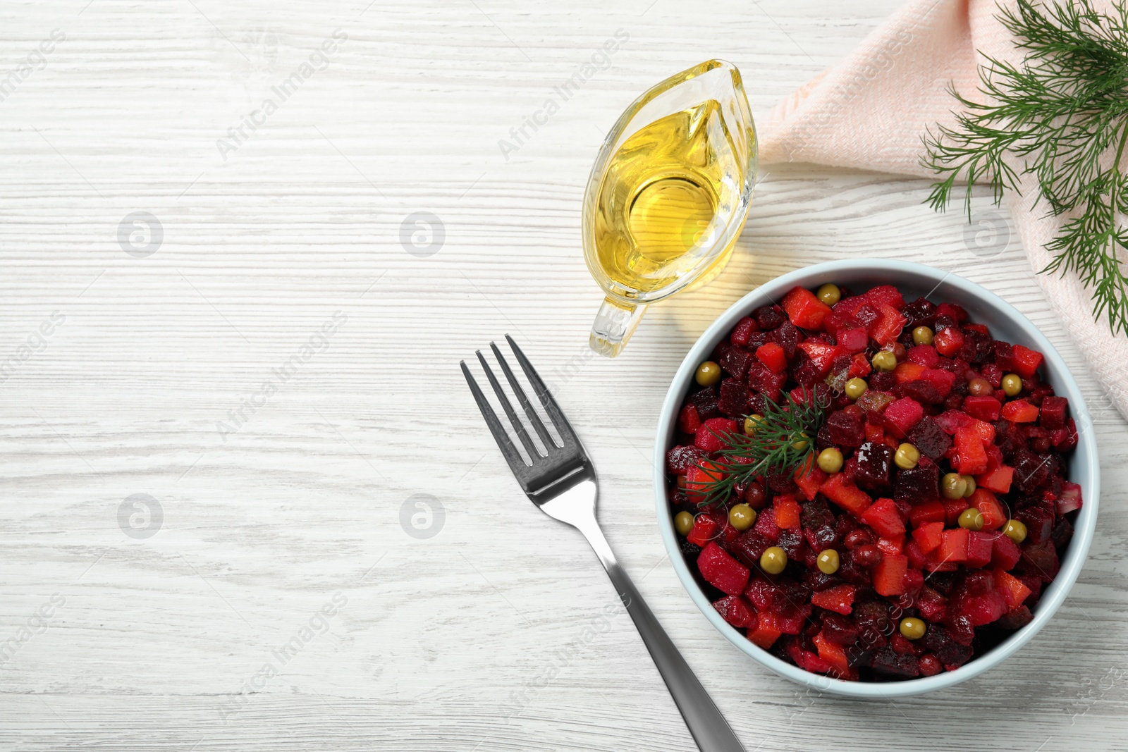 Photo of Traditional Russian vinaigrette salad on white wooden table, flat lay. Space for text