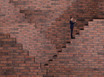 Man standing on stairs and looking at wrist watch. Way to success