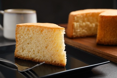 Piece of delicious fresh homemade cake served on grey table