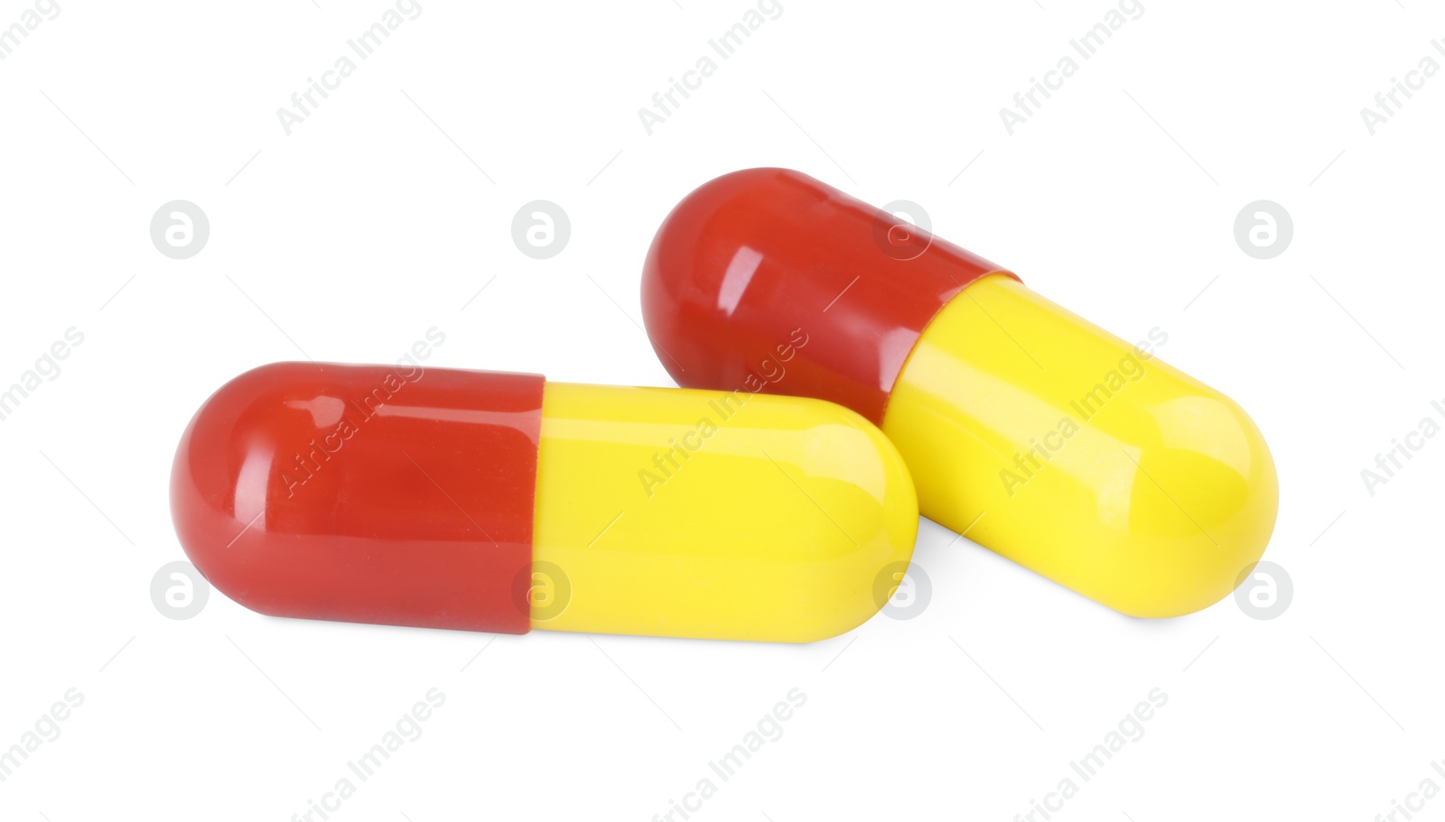 Photo of Two antibiotic pills isolated on white. Medicinal treatment