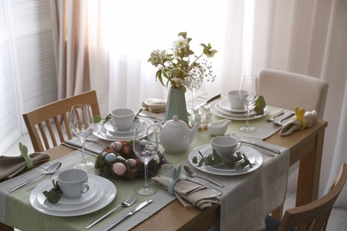 Photo of Beautiful Easter table setting with festive decor indoors