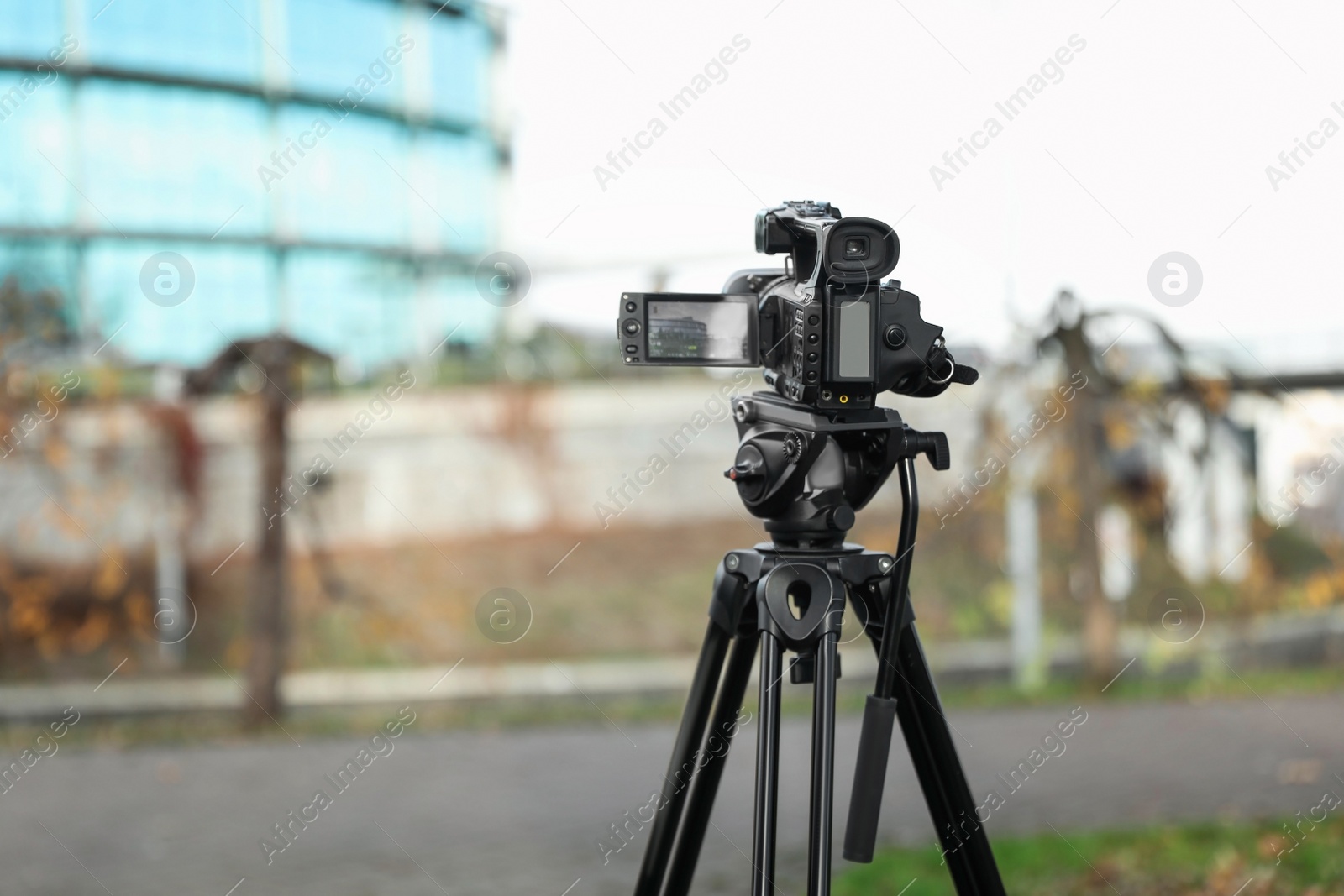 Photo of Professional video camera outdoors. Space for text