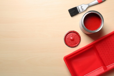 Flat lay composition with paint can and brush on wooden background. Space for text